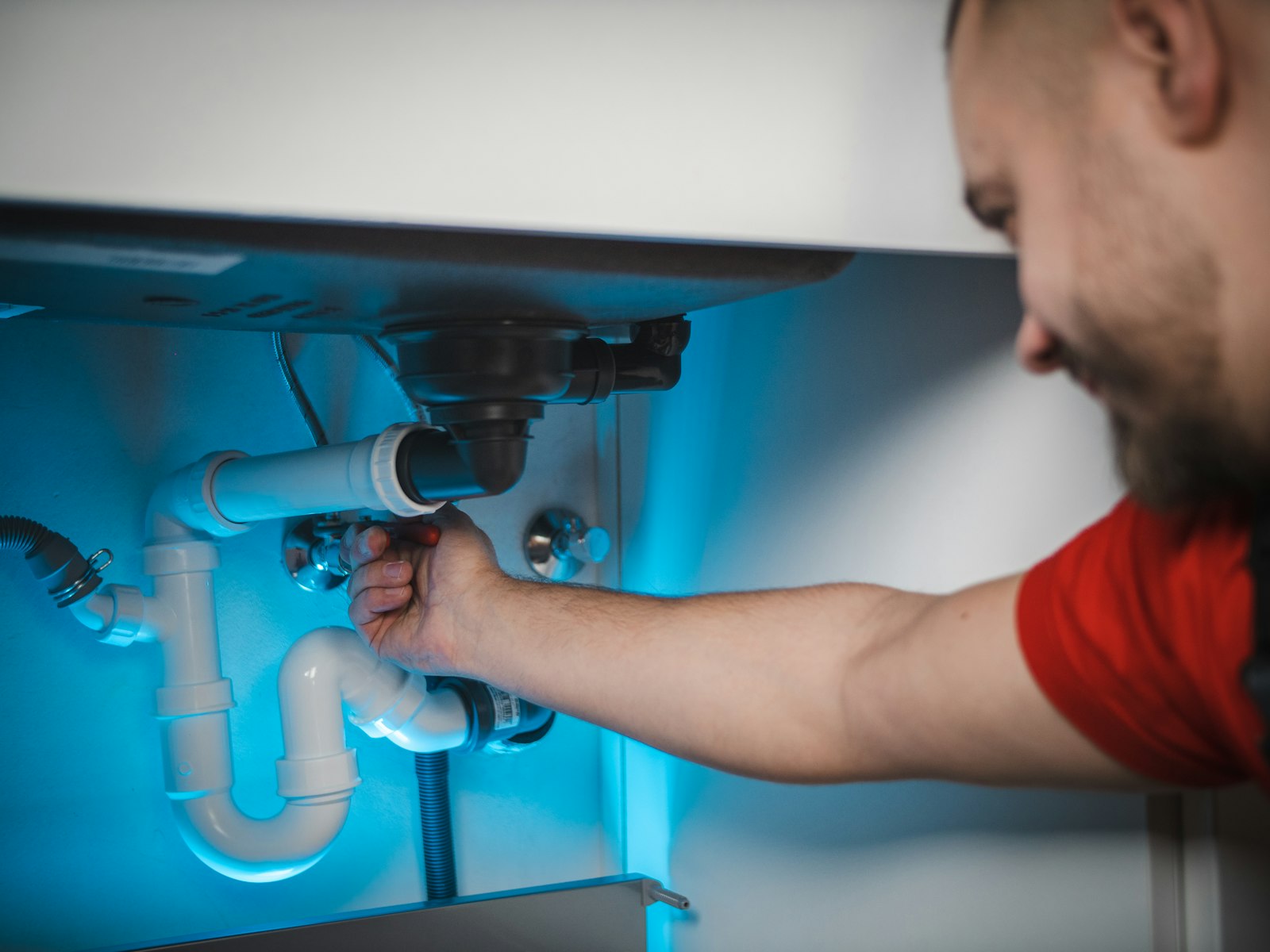 Blue Creek Plumbing technician repairing a pipe on a residential job site