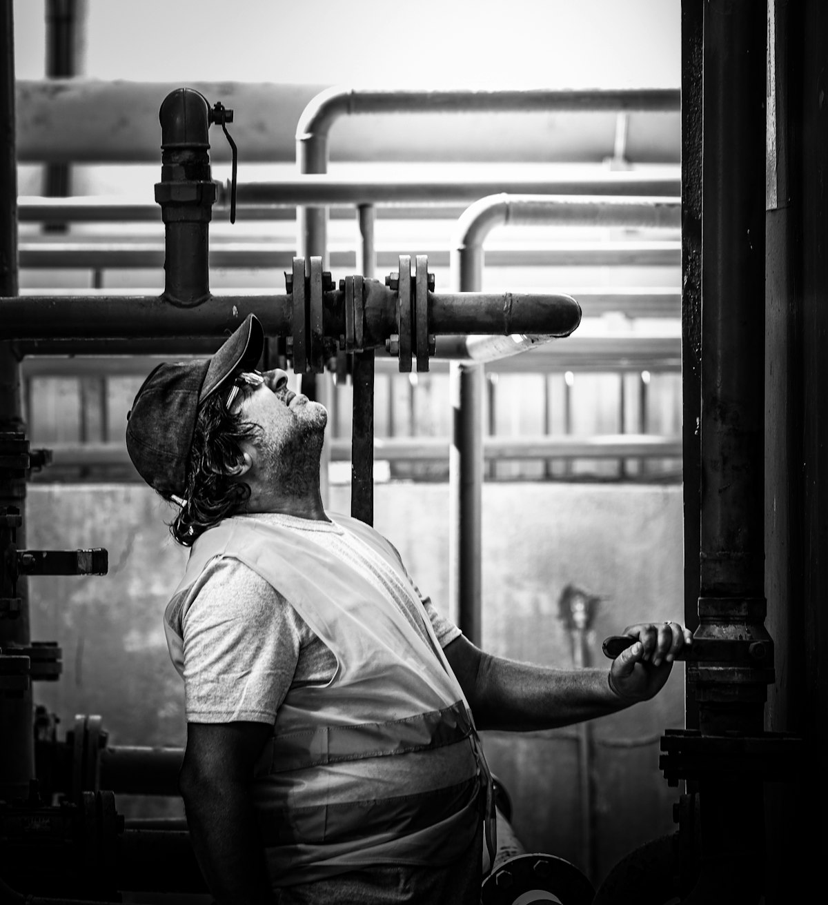 Blue Creek Plumbing technician inspecting pipes and valves on a job site
